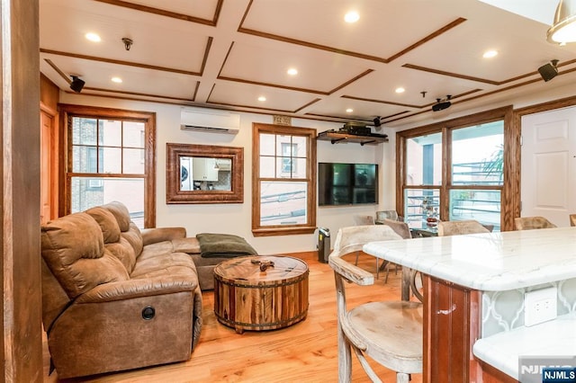 kitchen with coffered ceiling, a kitchen breakfast bar, open floor plan, a wall mounted AC, and light wood finished floors