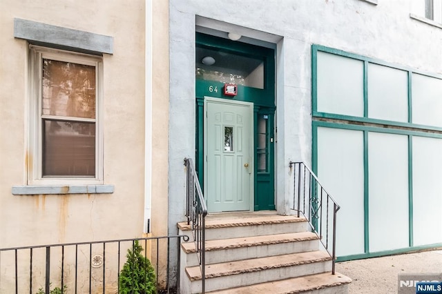 entrance to property featuring stucco siding