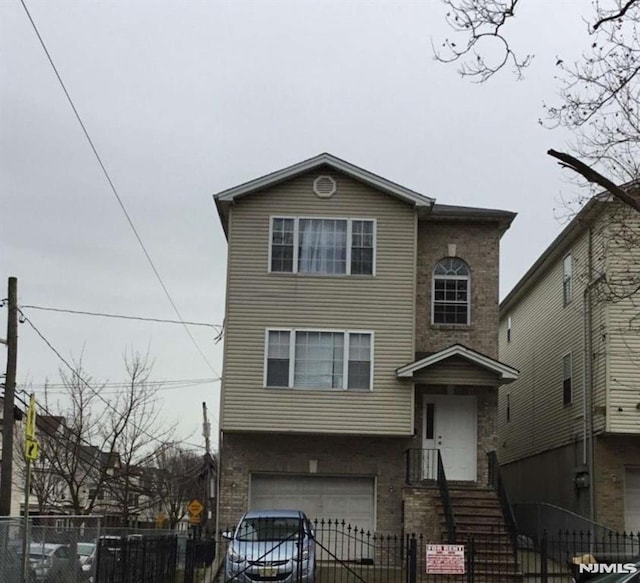 view of front facade featuring a fenced front yard and an attached garage