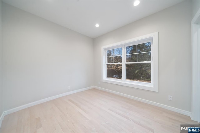 unfurnished room featuring light wood-style floors, recessed lighting, and baseboards