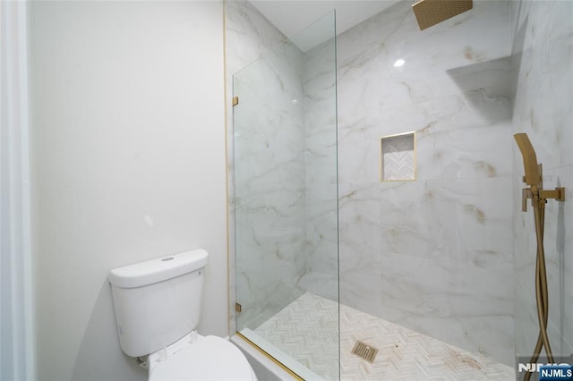 full bath with toilet and a marble finish shower