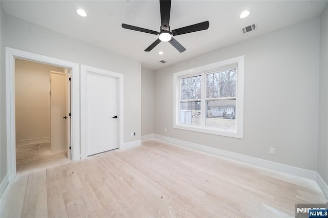 unfurnished bedroom with visible vents, light wood-style flooring, and recessed lighting