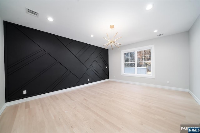 spare room with light wood-style floors, recessed lighting, visible vents, and baseboards