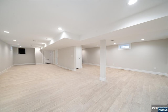 basement with baseboards, light wood finished floors, and recessed lighting