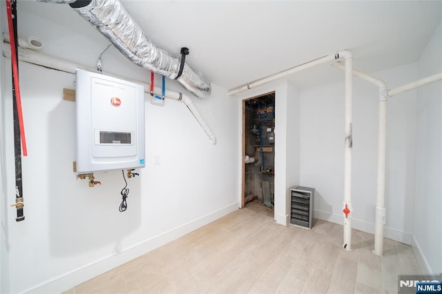 utility room featuring beverage cooler and water heater