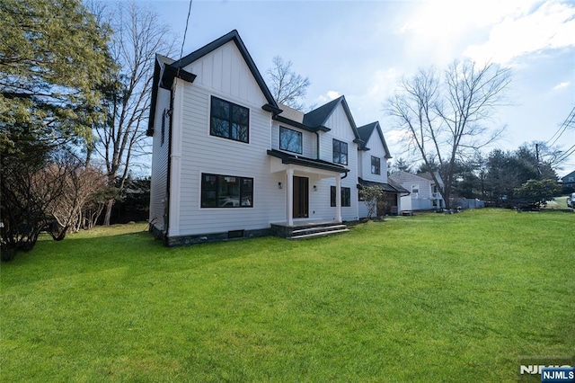 view of front of house with board and batten siding and a front yard