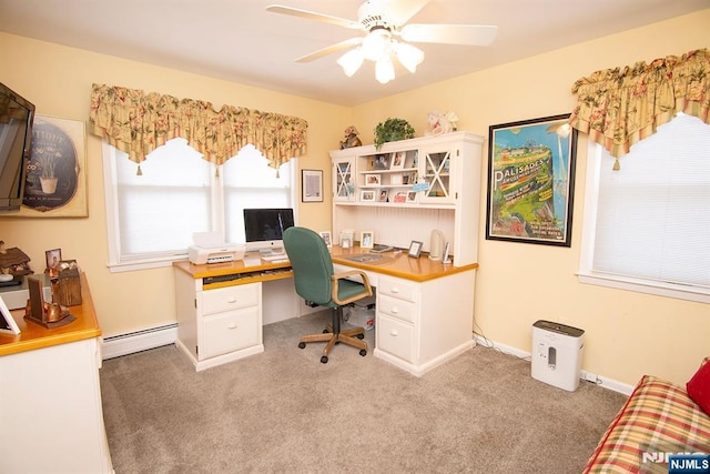 office area with baseboards, baseboard heating, a ceiling fan, and carpet