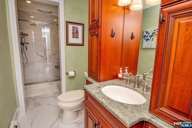 bathroom featuring a marble finish shower, a baseboard heating unit, toilet, marble finish floor, and vanity