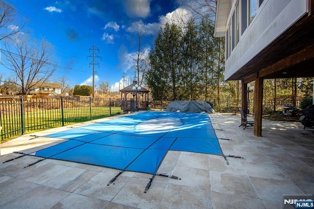 view of swimming pool featuring a gazebo, a fenced in pool, a patio, and fence