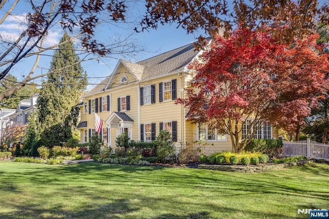 view of front of house featuring a front yard and fence