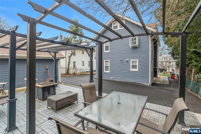 wooden deck featuring outdoor dining area, a fire pit, fence, a pergola, and a patio area