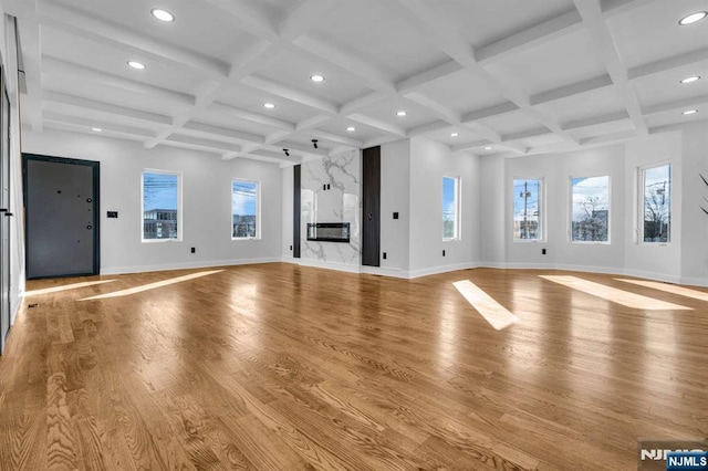 unfurnished living room with light wood-type flooring, baseboards, coffered ceiling, and recessed lighting