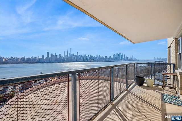 balcony with a water view and a city view