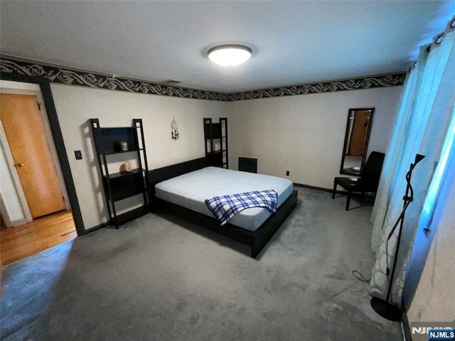 carpeted bedroom featuring baseboards