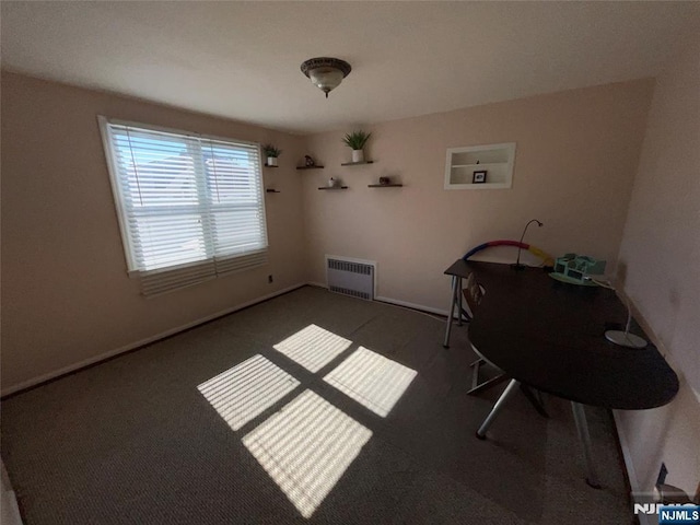 unfurnished dining area featuring carpet floors, radiator, and baseboards