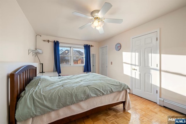 bedroom featuring a baseboard heating unit and ceiling fan