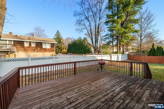 deck with a fenced backyard