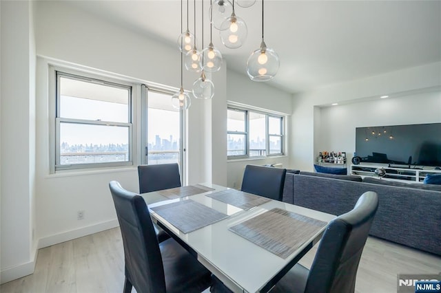 dining room with baseboards and light wood finished floors