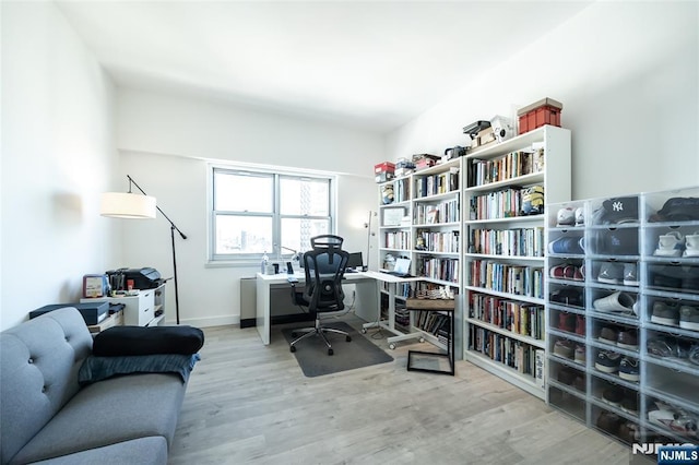 home office featuring baseboards and wood finished floors