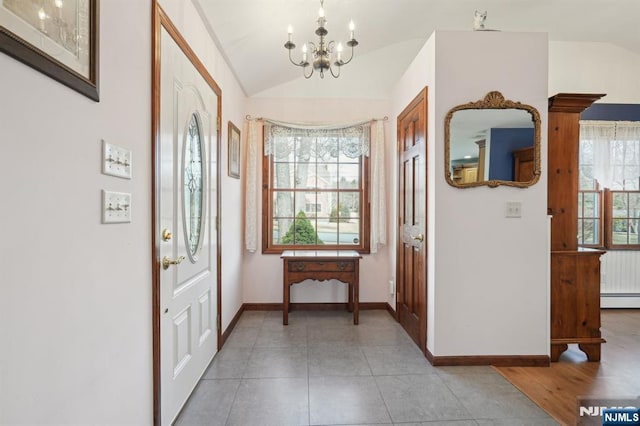 foyer with lofted ceiling, plenty of natural light, and a baseboard radiator