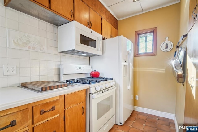 kitchen with tasteful backsplash, brown cabinets, white appliances, and light countertops