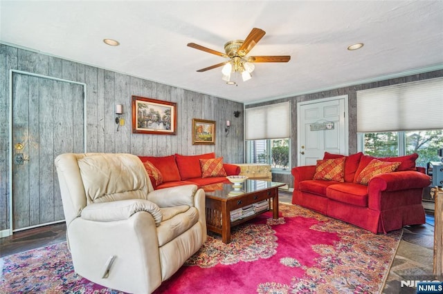 living room with recessed lighting, a baseboard heating unit, and a ceiling fan