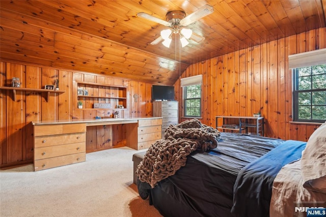 bedroom with carpet floors, wood ceiling, wood walls, and vaulted ceiling