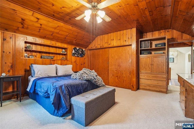 bedroom featuring light colored carpet, wood ceiling, and lofted ceiling