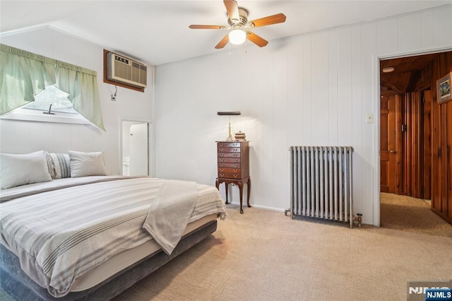 bedroom featuring ceiling fan, radiator, light colored carpet, and a wall mounted AC