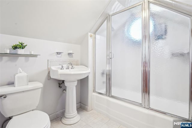 full bath featuring tile patterned floors, toilet, combined bath / shower with glass door, baseboards, and vaulted ceiling