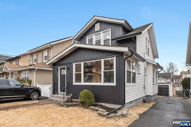 view of front of home with entry steps, board and batten siding, and an outdoor structure