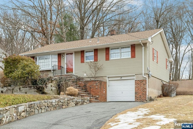 ranch-style home featuring aphalt driveway, roof with shingles, a chimney, and a garage