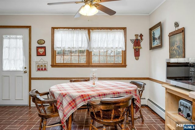 dining area with a wealth of natural light, brick floor, and a baseboard radiator