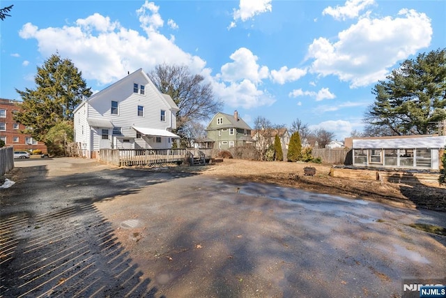 view of yard with a deck and fence