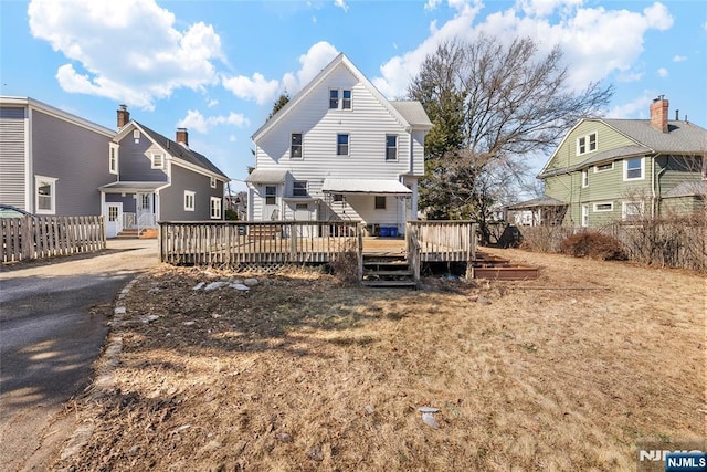 rear view of property with a wooden deck and a residential view