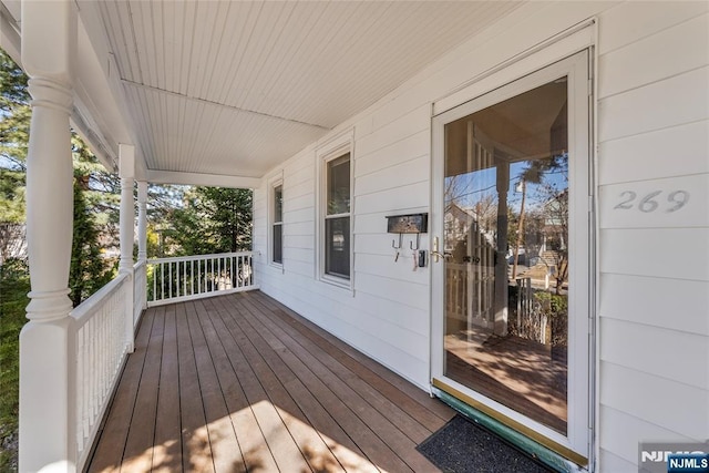 wooden terrace featuring covered porch