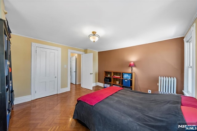 bedroom featuring radiator, baseboards, and ornamental molding