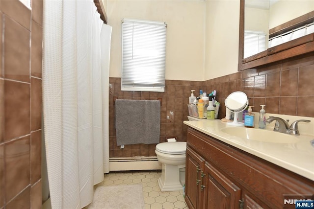 bathroom with curtained shower, toilet, vanity, tile walls, and a baseboard radiator