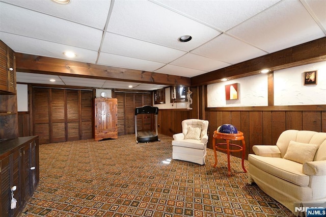 interior space with recessed lighting, wainscoting, wooden walls, and a drop ceiling