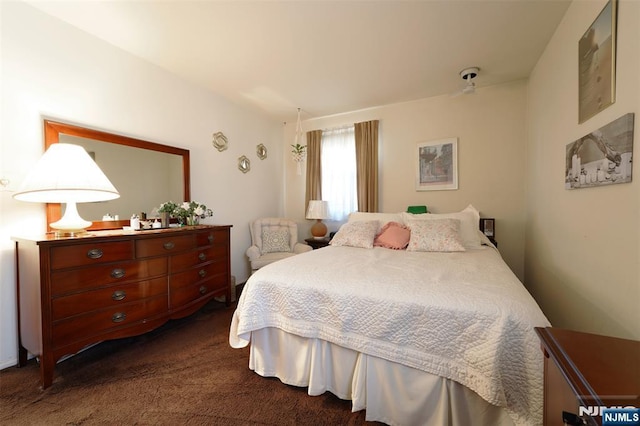 bedroom with dark colored carpet