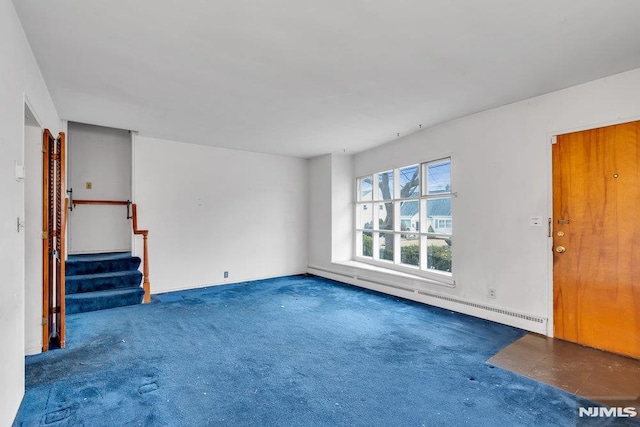 unfurnished living room featuring stairs, a baseboard radiator, and carpet flooring