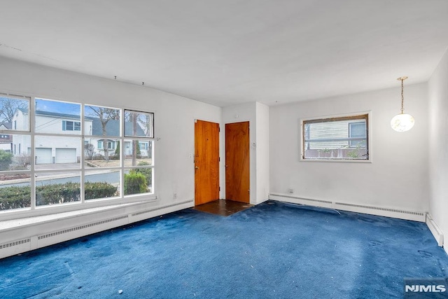 carpeted empty room with a baseboard radiator