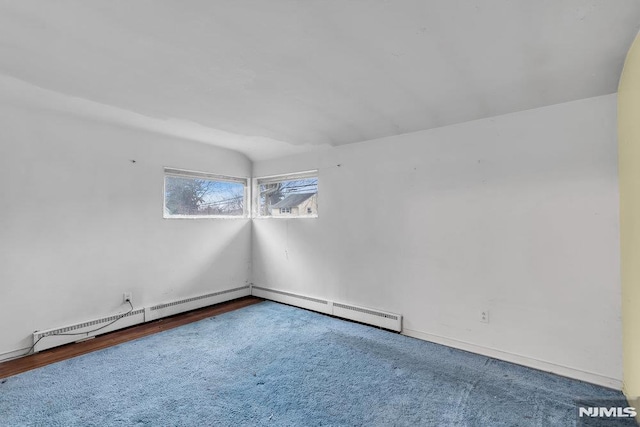 unfurnished room featuring baseboard heating