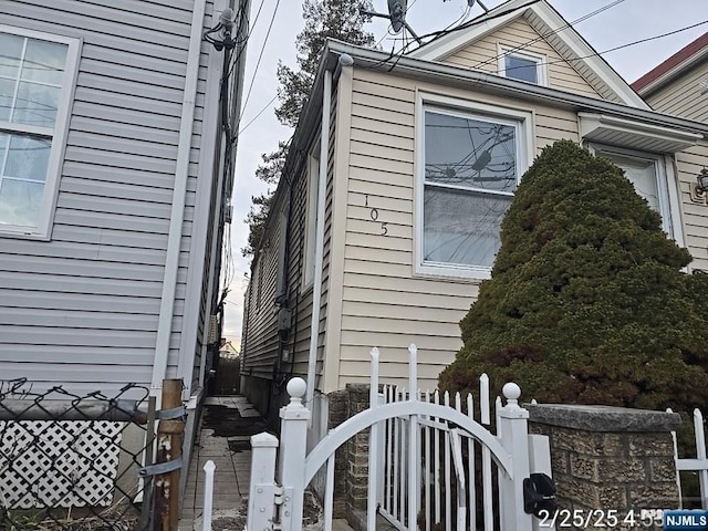 view of side of property featuring fence