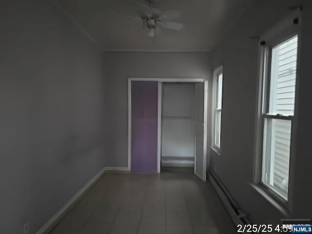 hall with light tile patterned floors and baseboards