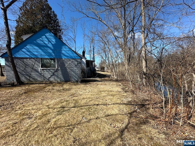 view of side of property featuring an outbuilding and a barn