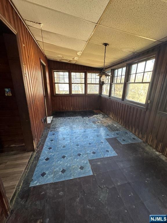 unfurnished sunroom featuring a paneled ceiling