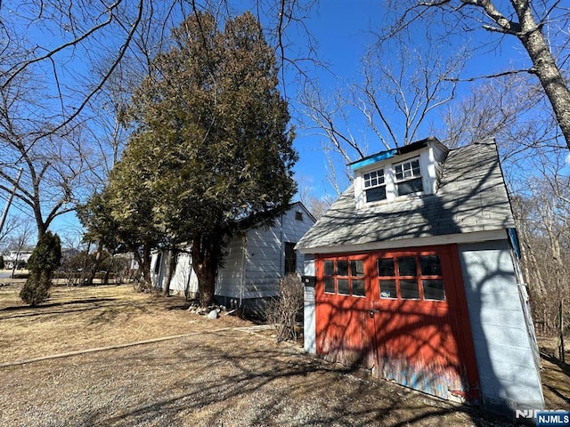 view of property exterior with an outbuilding