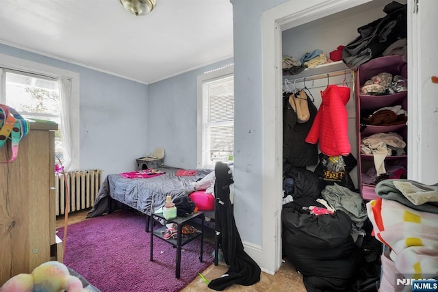 bedroom featuring radiator heating unit and crown molding