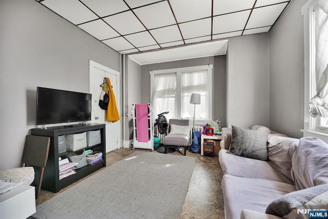 living room with a drop ceiling